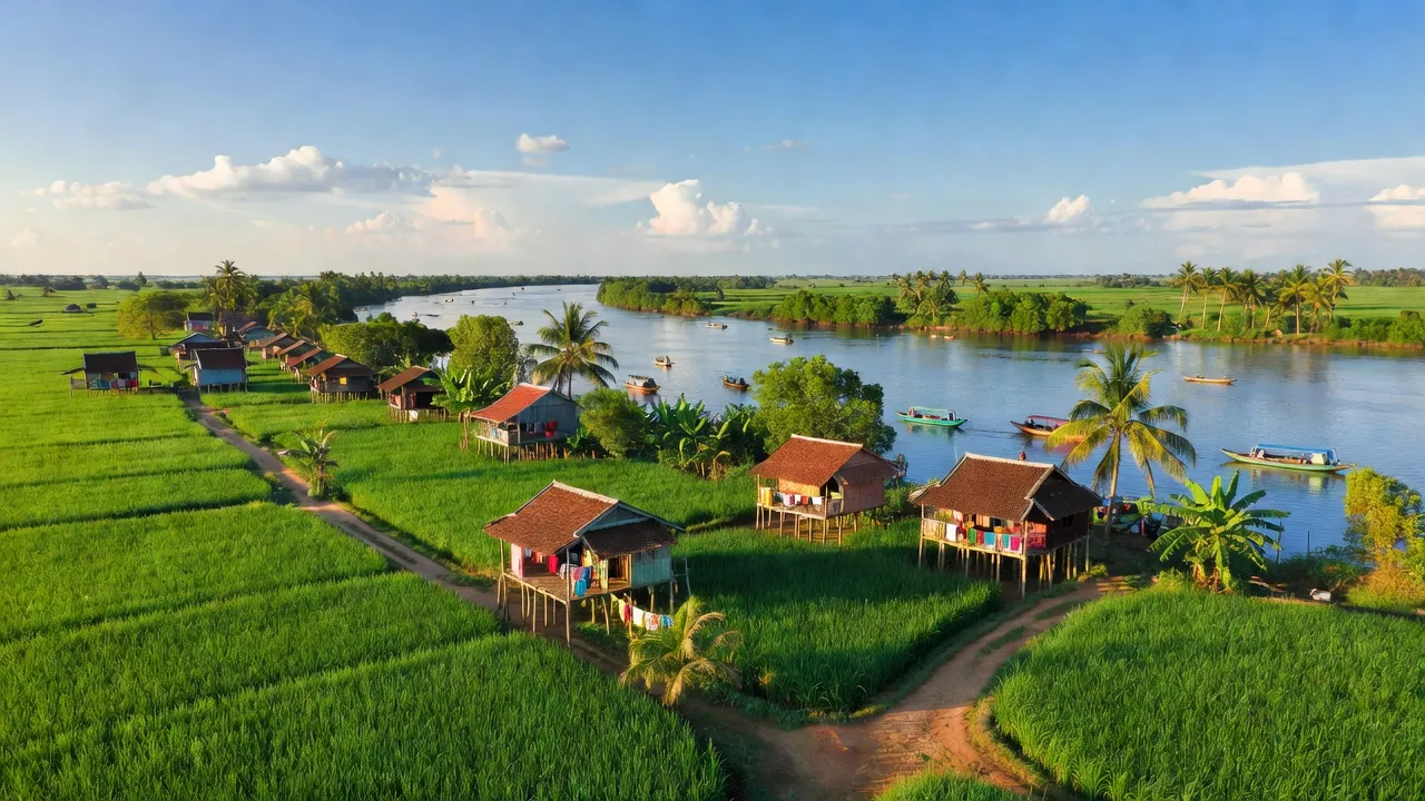 Trà Lồng, Long Mỹ, Hậu Giang: lush fields, houses, Mekong Delta river under blue sky.